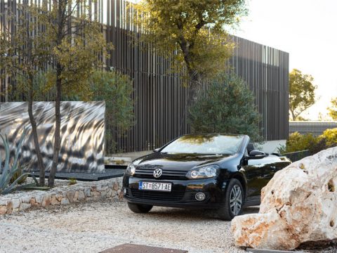 At Stari Grad, Hvar, a Volkswagen Golf VI Cabriolet is parked in front of Maslina Resort.